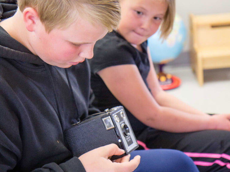 Students examining a camera