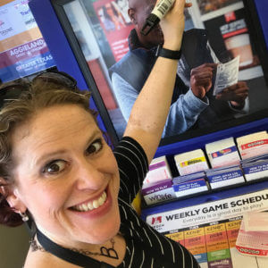 employee smiling while cleaning playstation