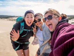 women enjoying the Oregon Coast