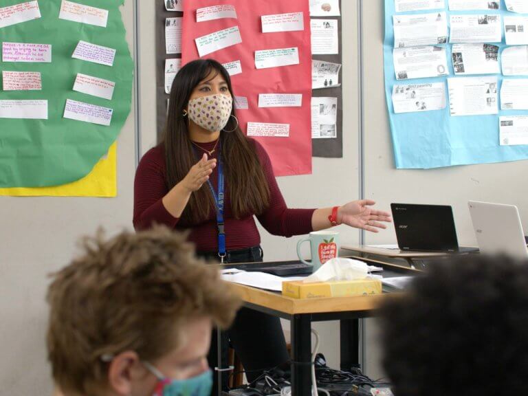 Ethelyn teaching at the front of her classroom